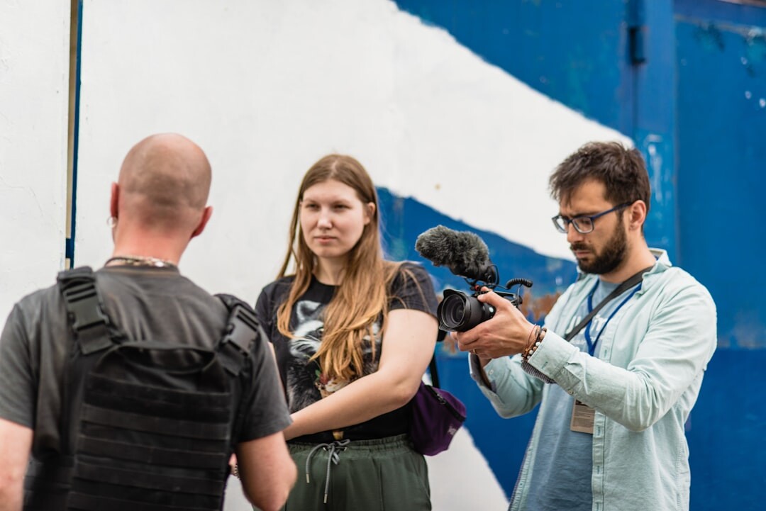 Trainees practicing camera framing during a video journalism workshop