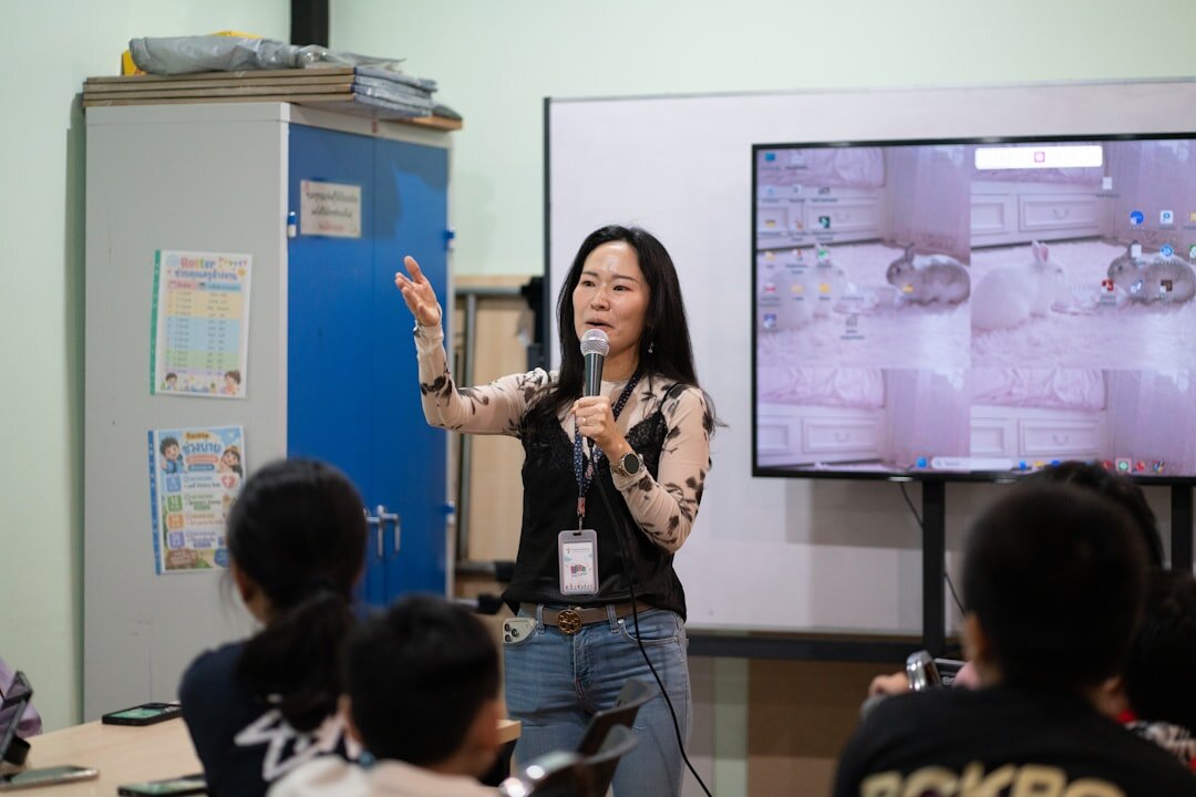 Group of trainees learning video reporting techniques with cameras in a classroom